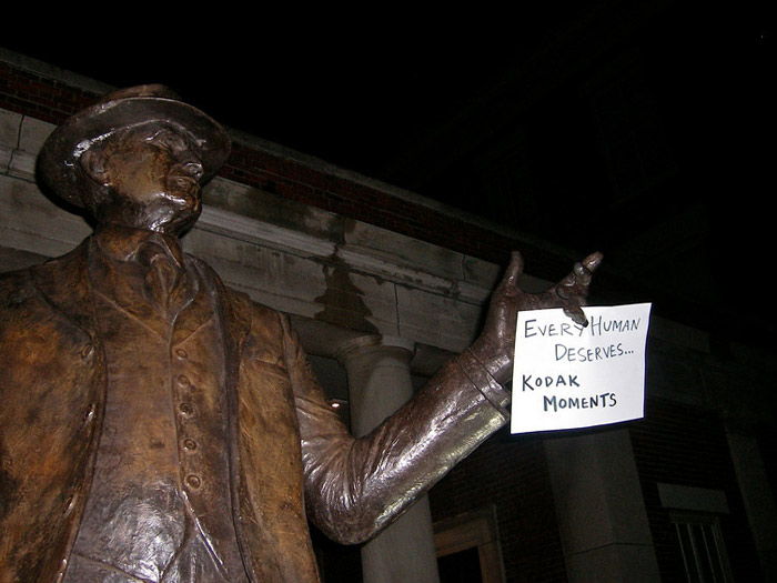 student holding sign that reads KODAK MOMENTS