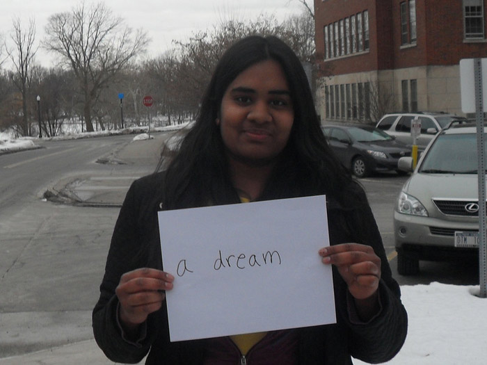 student holding sign that reads A DREAM