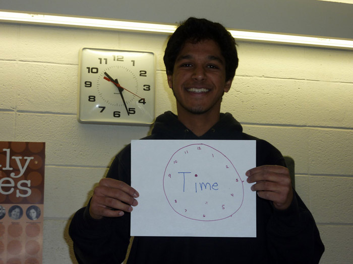 student holding sign that reads TIME