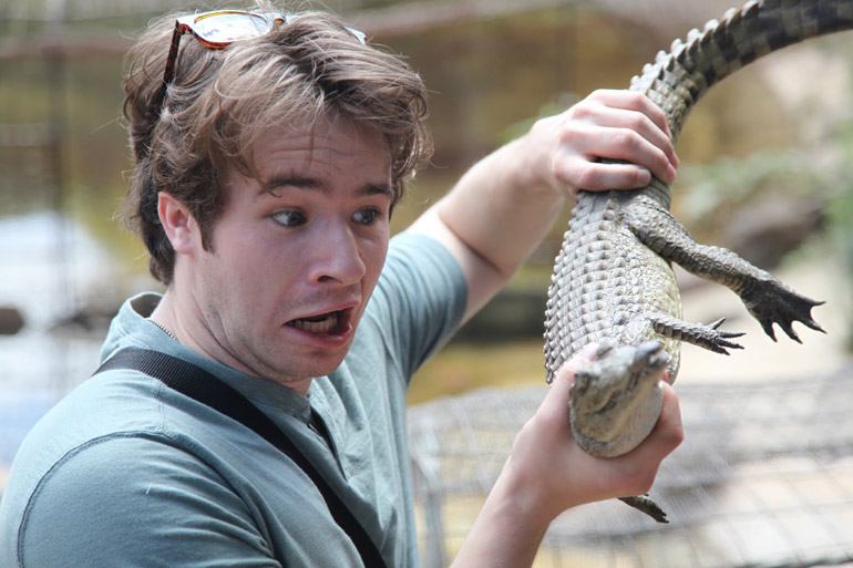 student holds alligator