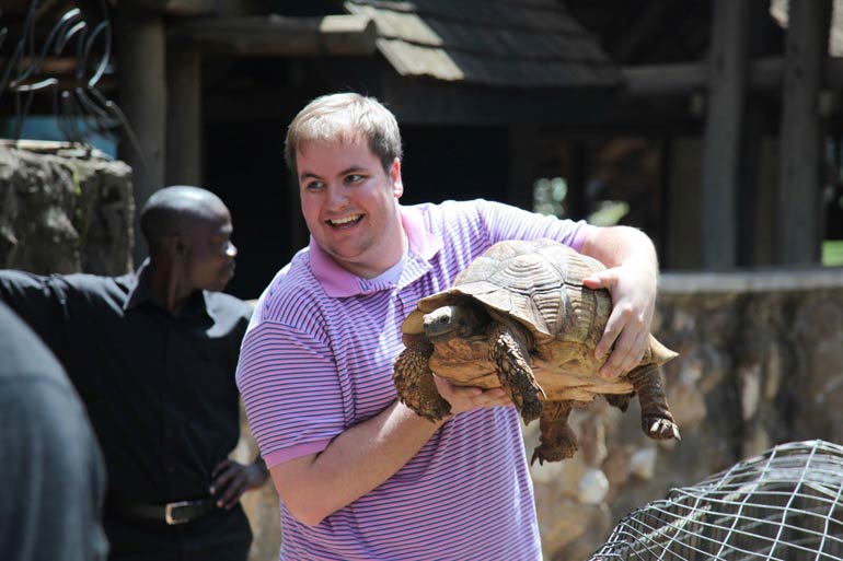 student holds tortoise