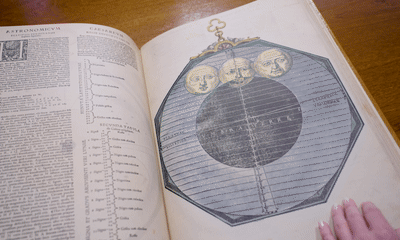 Gif of a hand flipping through the pages of a facsimile of Astronomicum Caesareum by Petrus Apianus.