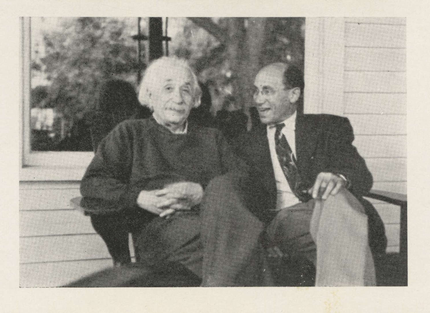 Vintage black-and-white photo of Albert Einstein seated on porch bench with Frank Gerald Back.
