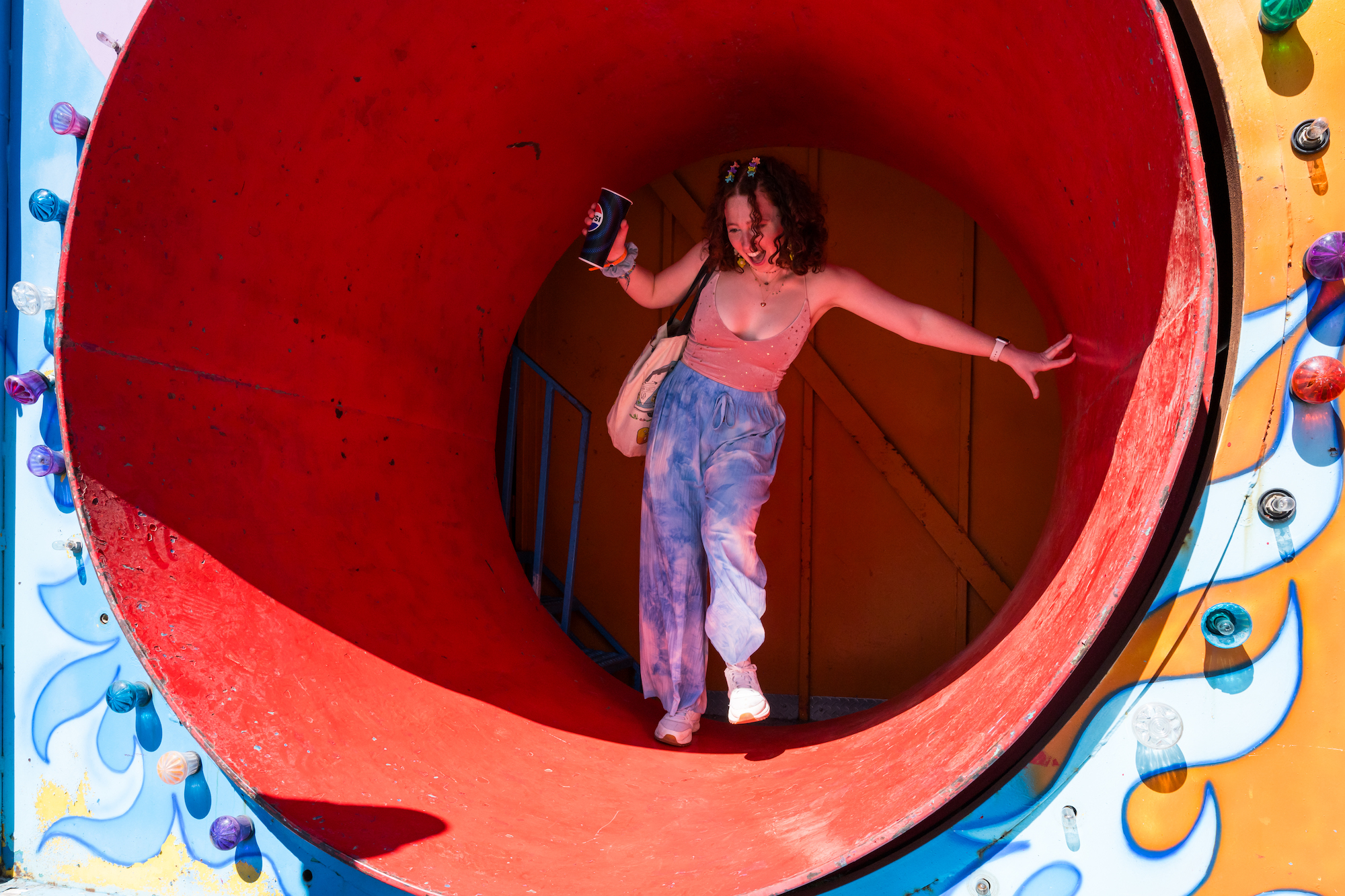 Student emerges from a rotating cylinder as part of a fun house