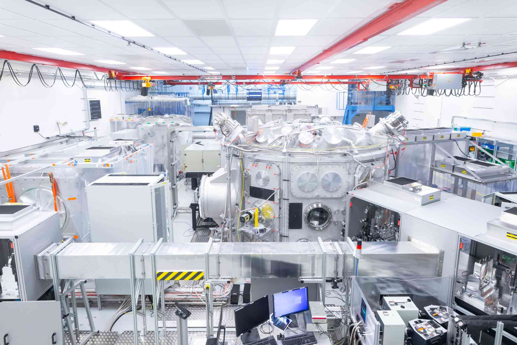 Wide shot of a bright room filled with the equipment required to run ultrahigh intensity laser experiments to test the possibility of producing coherent gamma rays.