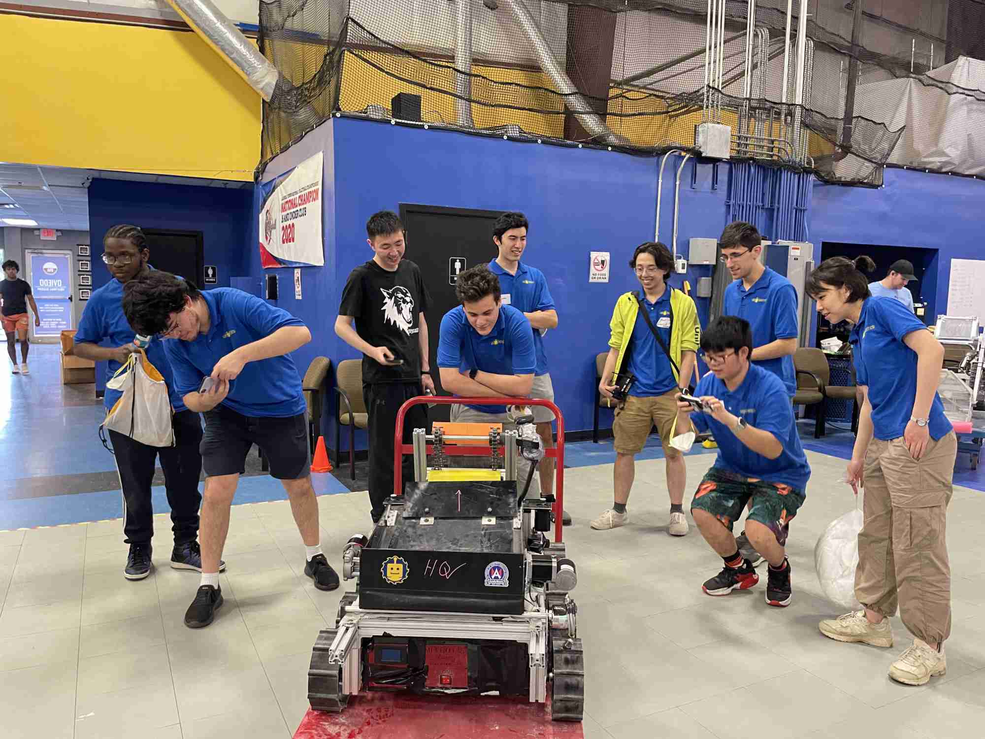 Undergraduate engineering students in matching t-shirts with their lunar rover robot for NASA's 2024 Lunabotics Challenge.