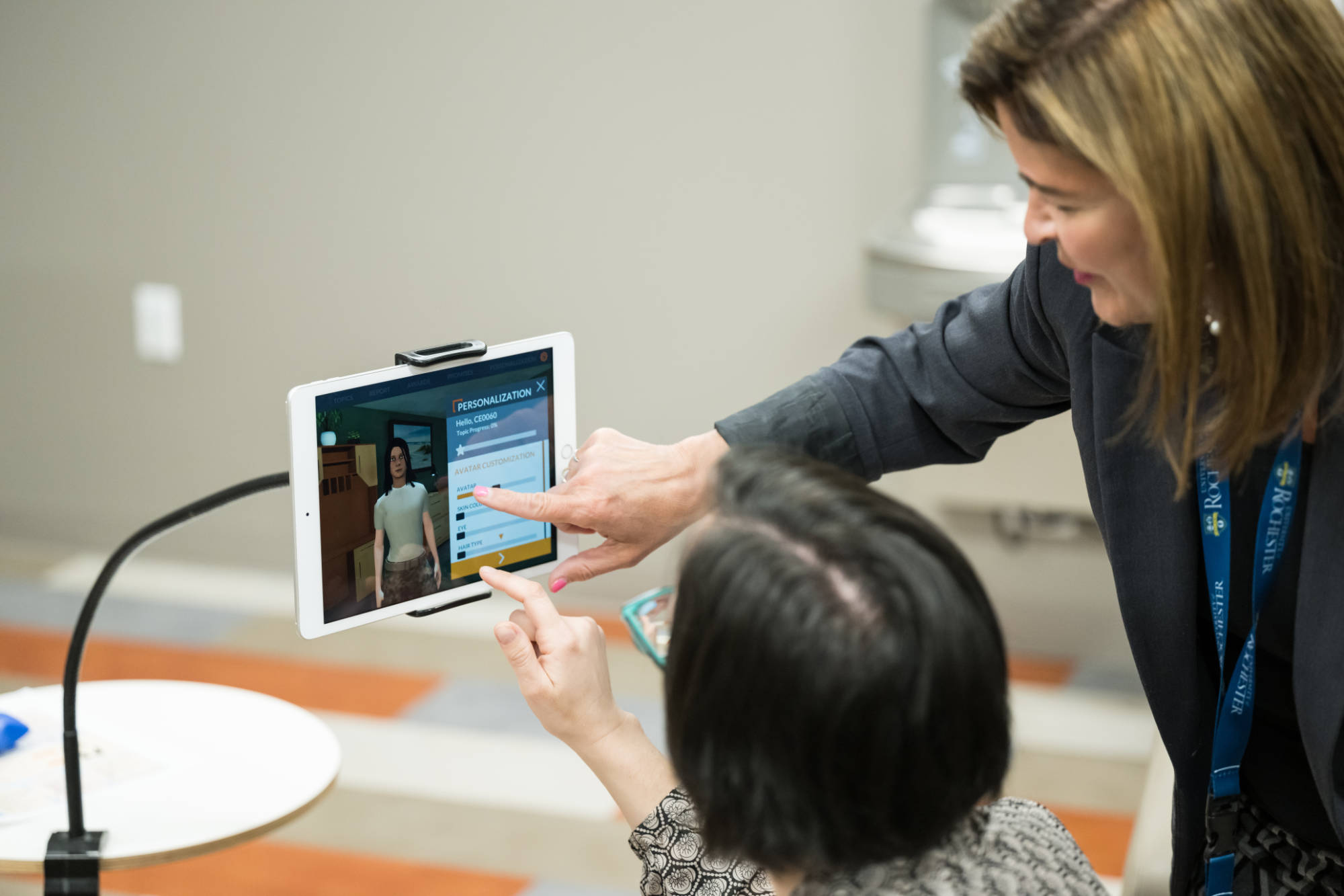 Two people seen from behind tapping on an iPad to customize an AI avatar. 