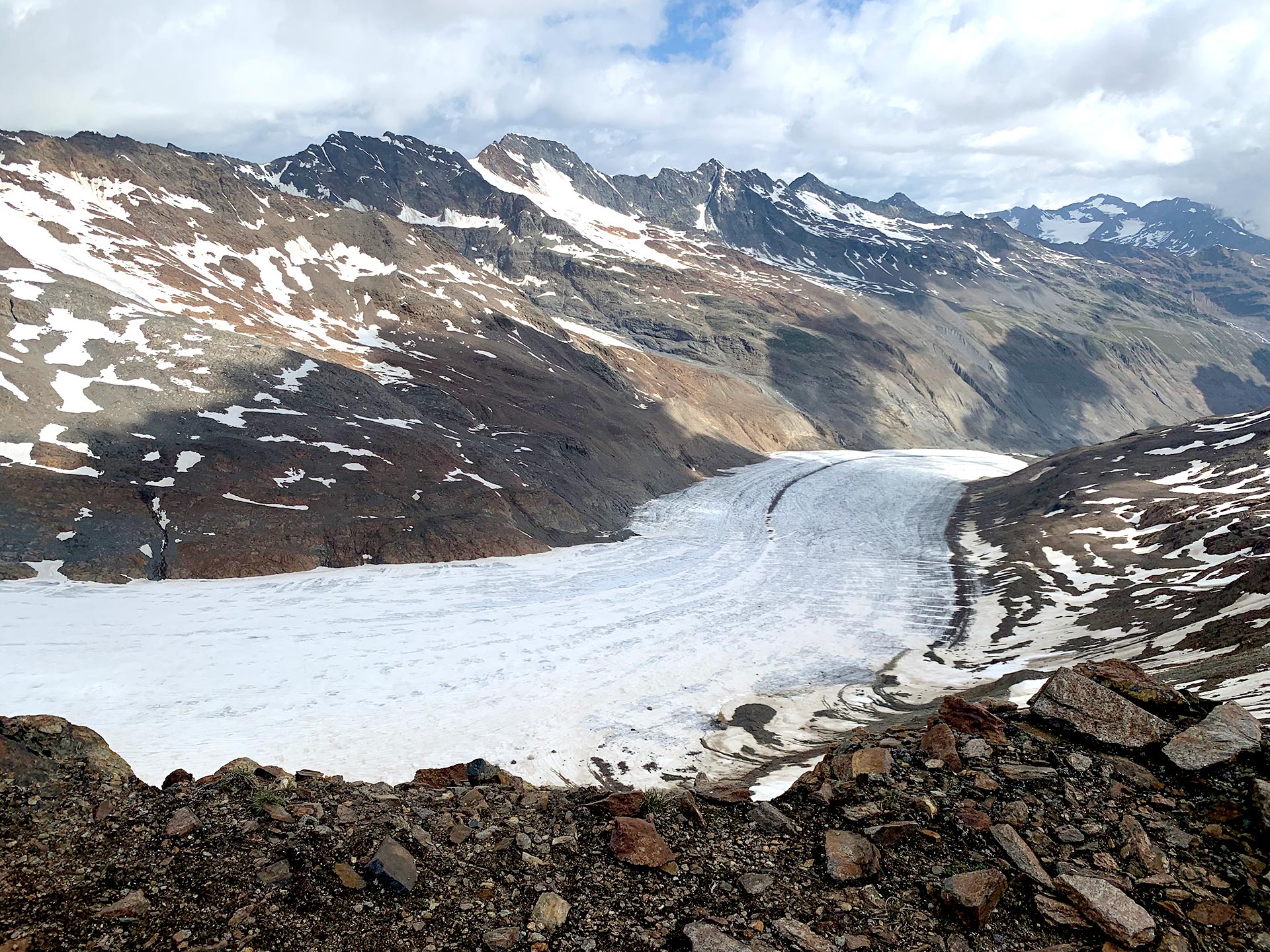 A glacier, appearing like a river of ice flowing in a mountain range. 