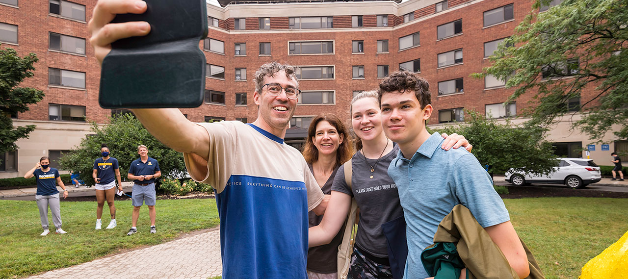 Family poses for a selfie together during move-in.