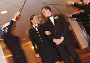 Dressed Up: An arch of swords forms the entrance to the NROTC ball for Regan and her date Adam Simmons ’03.