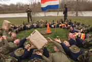 Muddy and Cold: . . . just the way they like it. Cadets get down and dirty in the battalion event war games.