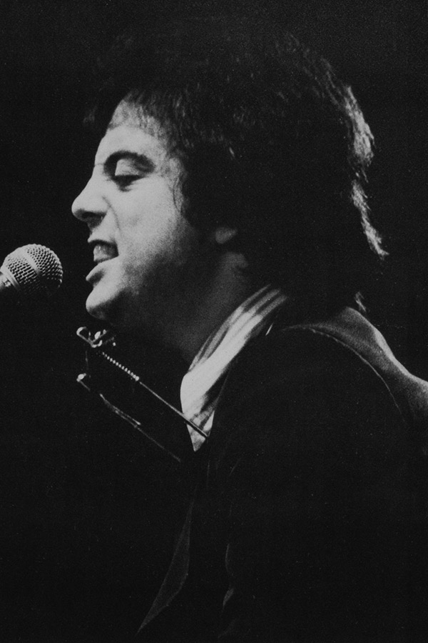 photo of musician Billy Joel playing the piano