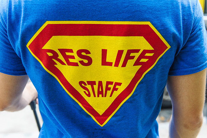 A person wearing a res life staff T-shirt.