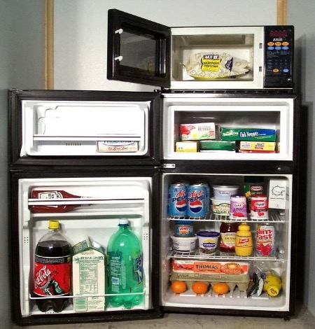 The inside of the microfridge stocked with food.