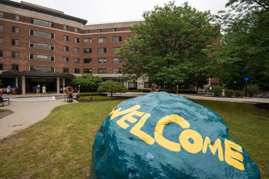 Welcome painted on the large rock outside SBA Hall.