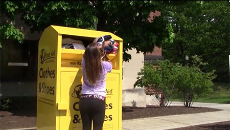 young woman putting clothes in a bin