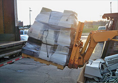 e-waste being front-loaded into a truck