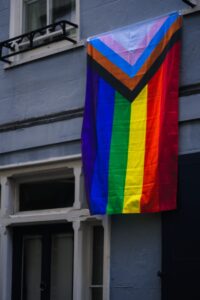 Progress pride flag hanging on a building