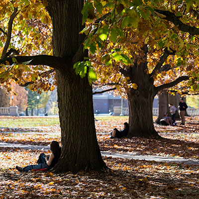 A student sitting by themselves looking pensive.
