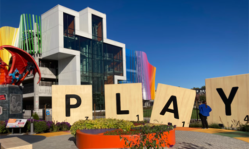 An exterior view of the museum featuring the giant Scrabble letters that spell the word PLAY.