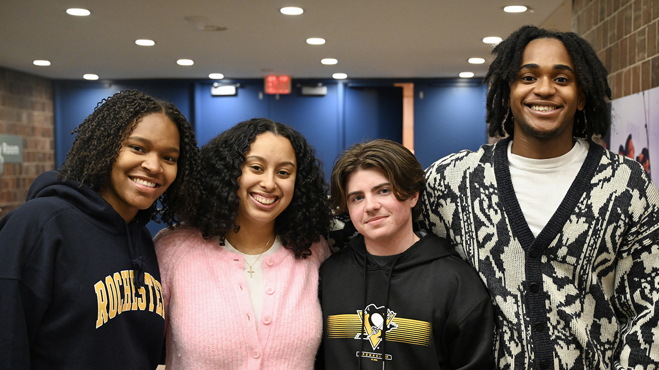 A group photo of four smiling students.