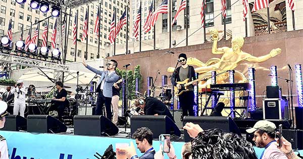 Dr. Jeffrey Le ’07 performing on stage with his band in Rockefeller Center