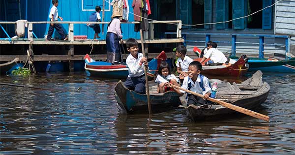 kids in boats on their way to school in Cambodia