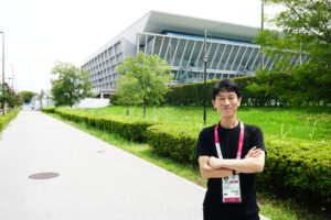 Takuya Adachi ’04S (MBA) in front of the Tokyo Aquatics Centre