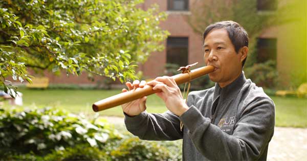 Jefferson Svengsouk playing a wooden flute