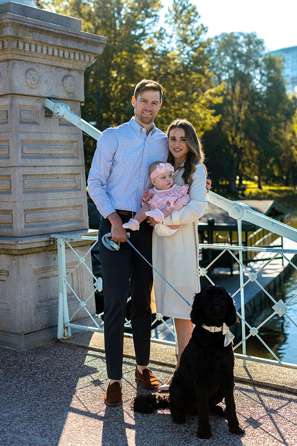 Bridgitte Mott ’09 takes a picture with her husband, daughter and dog. 