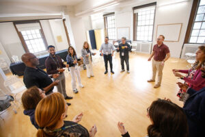 Volunteers participating in an improv-focused breakout session, led by Tim Ryan.