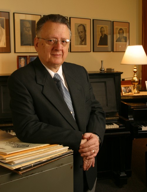 Vincent Lenti posing in a suit leaning against a cabinet