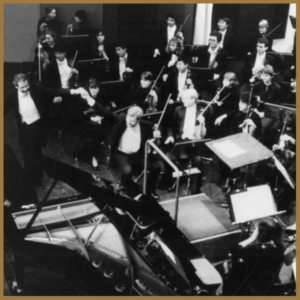 black and white image of orchestra with conductor