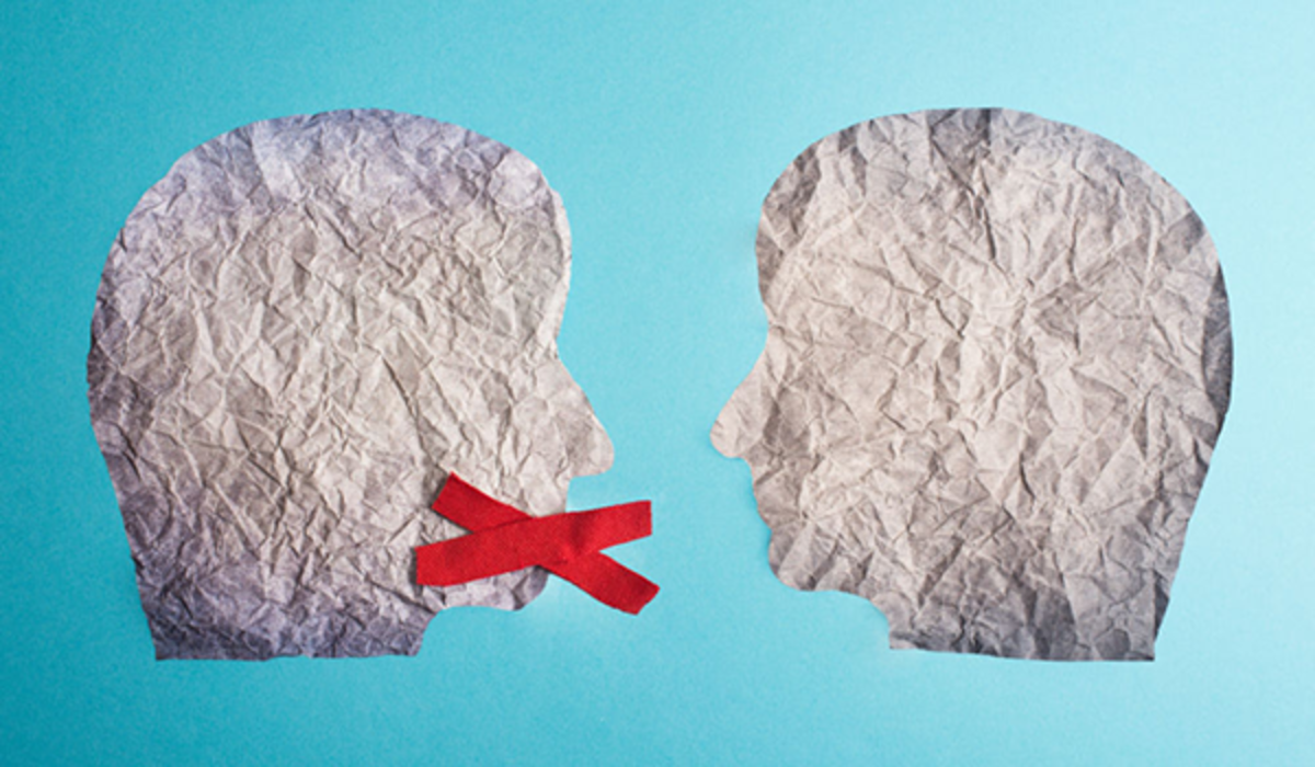 Two paper heads face each other, head on left has a red x over its mouth