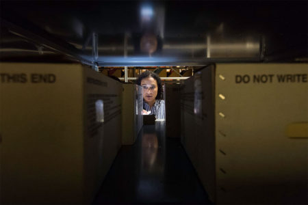 woman filing slaughter papers in storage