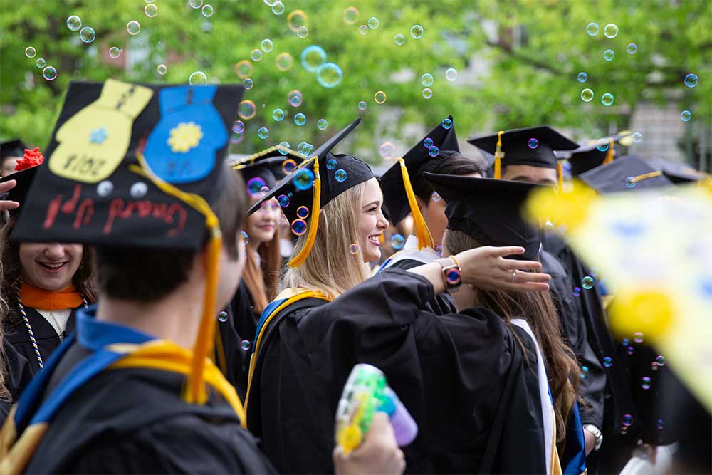 group of students celebration during graduation in their cap and gowns