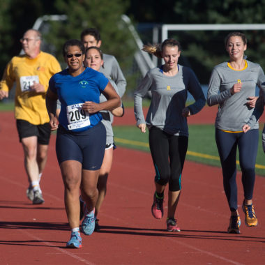 Lisa Norwood running on a track with several students