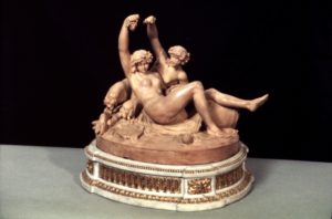 terracotta statue of two naked women with arms stretched in the air