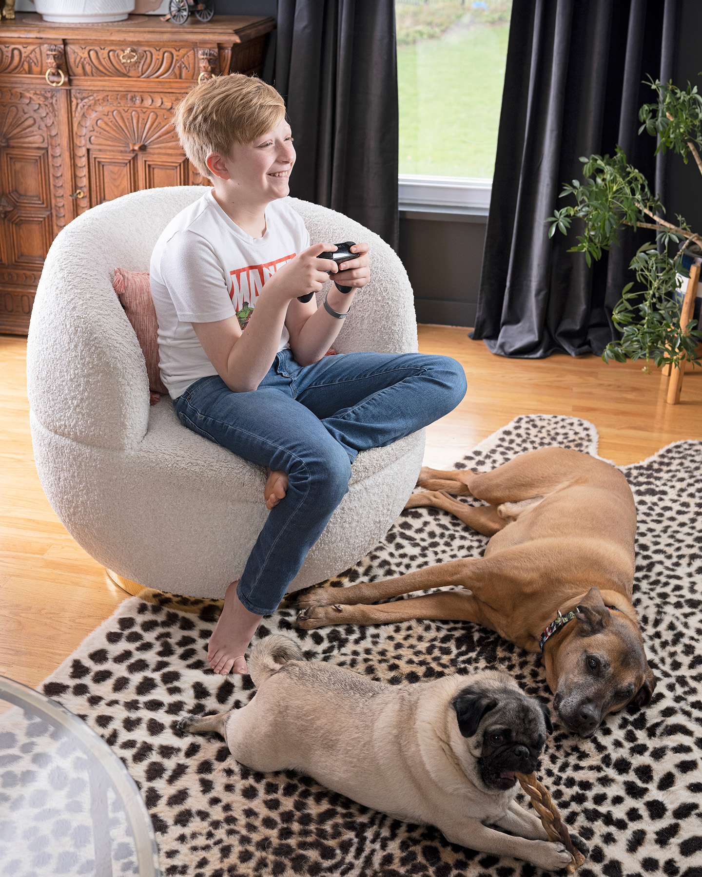 Jack play video games while his 2 dogs lay at his feet