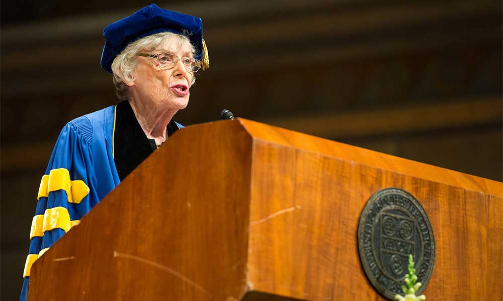 Dr. Ruth A. Lawrence ’49M (MD), ’58M (Res) at podium wearing graduation regalia