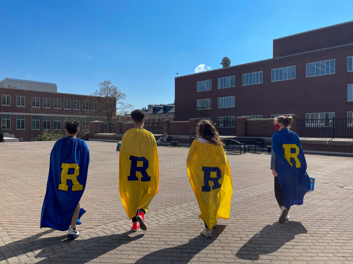 the back of 4 students wearing the letter "R"