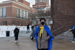 male student wearing a blue cape