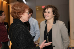 two women speaking to each other during an event