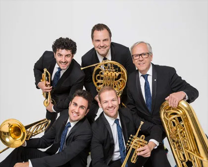 Five men in suits with brass instruments.