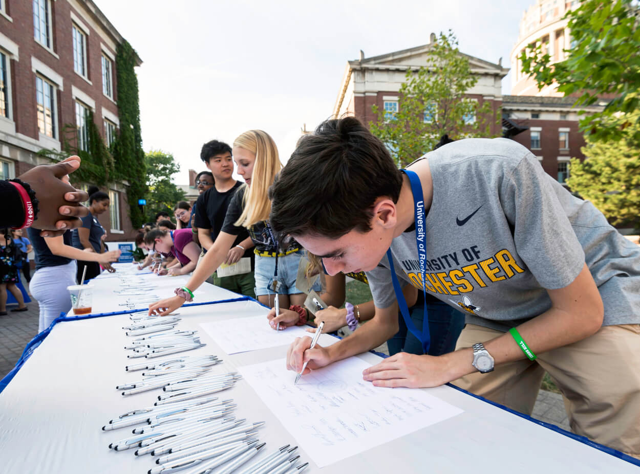 Students sign the class roll as part of a tradition at the University of Rochester