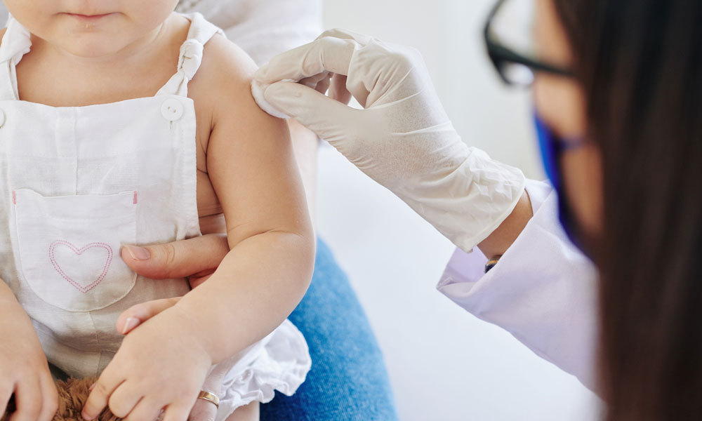 Child recieves vaccine in doctor's office.