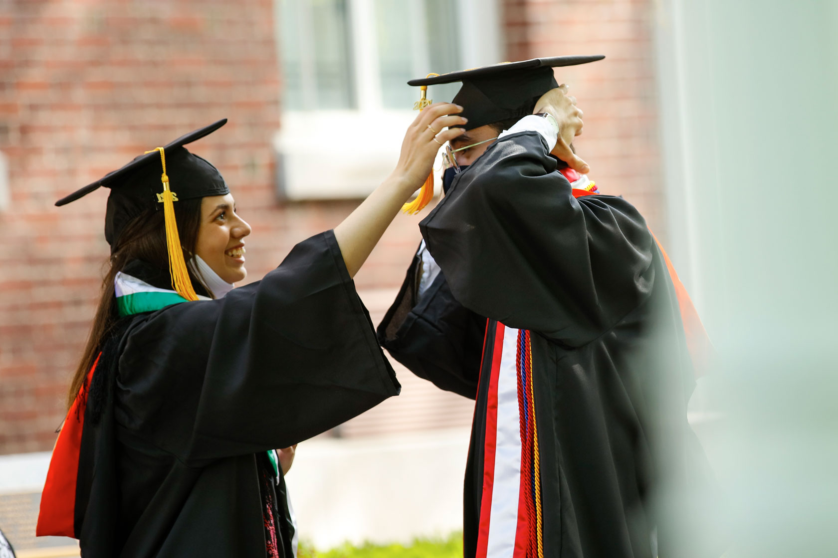 Students helping each-other prepare for commencement