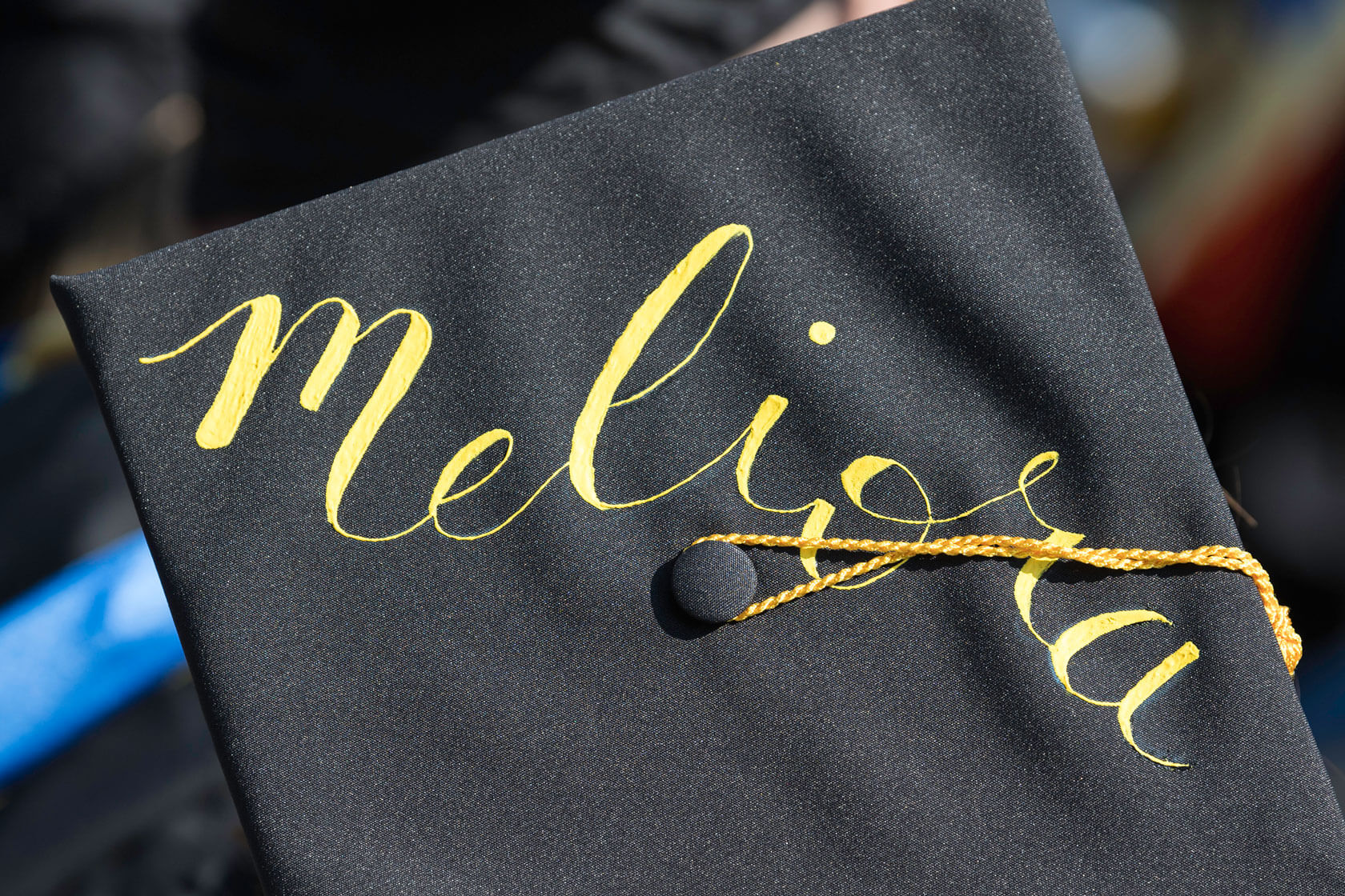 Meliora hand painted on a graduation cap.