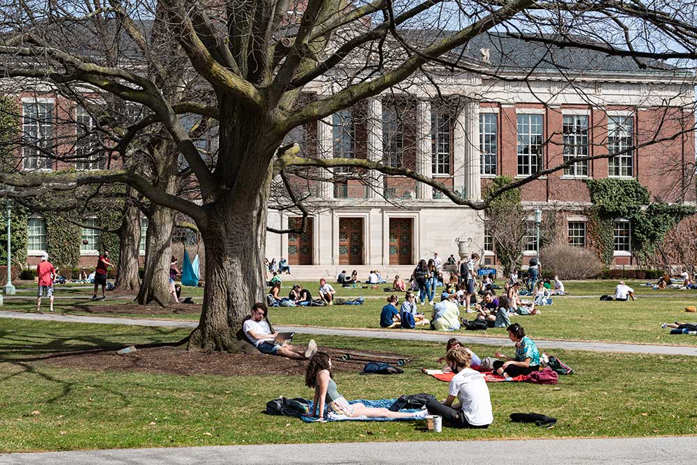 Students sitting in groups on the Eastman Quad.