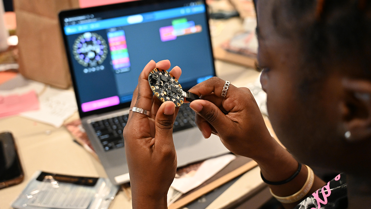 A student using a device to program.